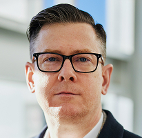 Headshot di Alexander Hughes, CEO di un'azienda di crypto trading